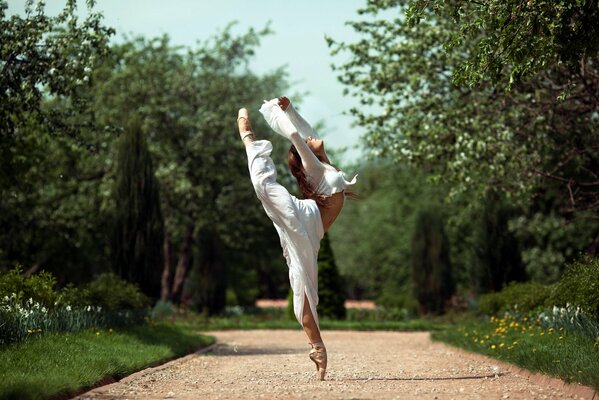 A ballerina girl in a white suit