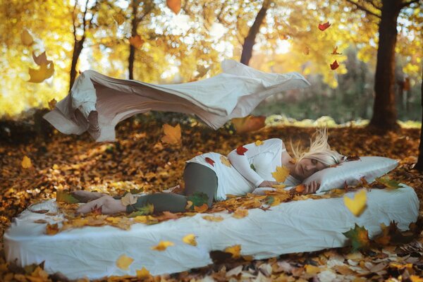 Girl sleeping on white in the woods