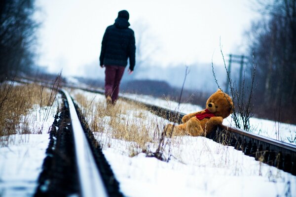 Teddy bear on rails in winter