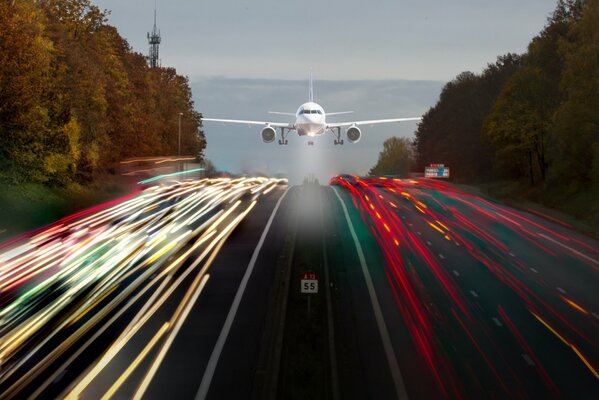 A plane that flies low over a road with bright stripes