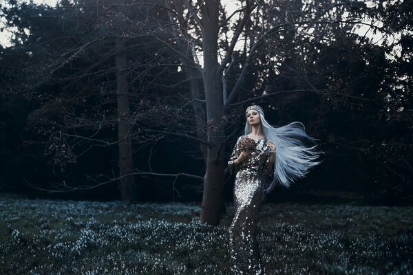 Beautiful photo of a girl in a dress with white hair in the forest