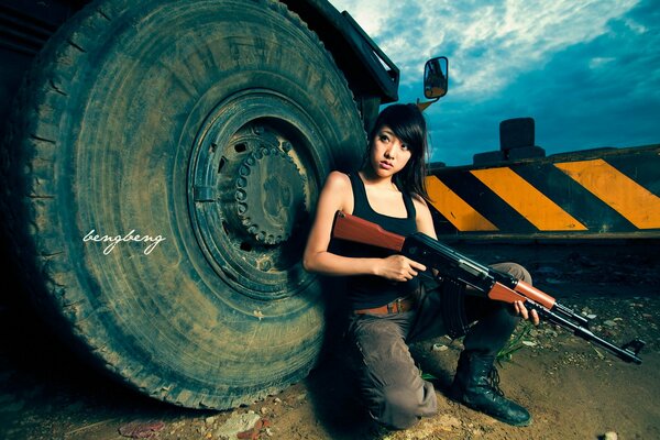 Dangerous Asian woman with a gun in her hands