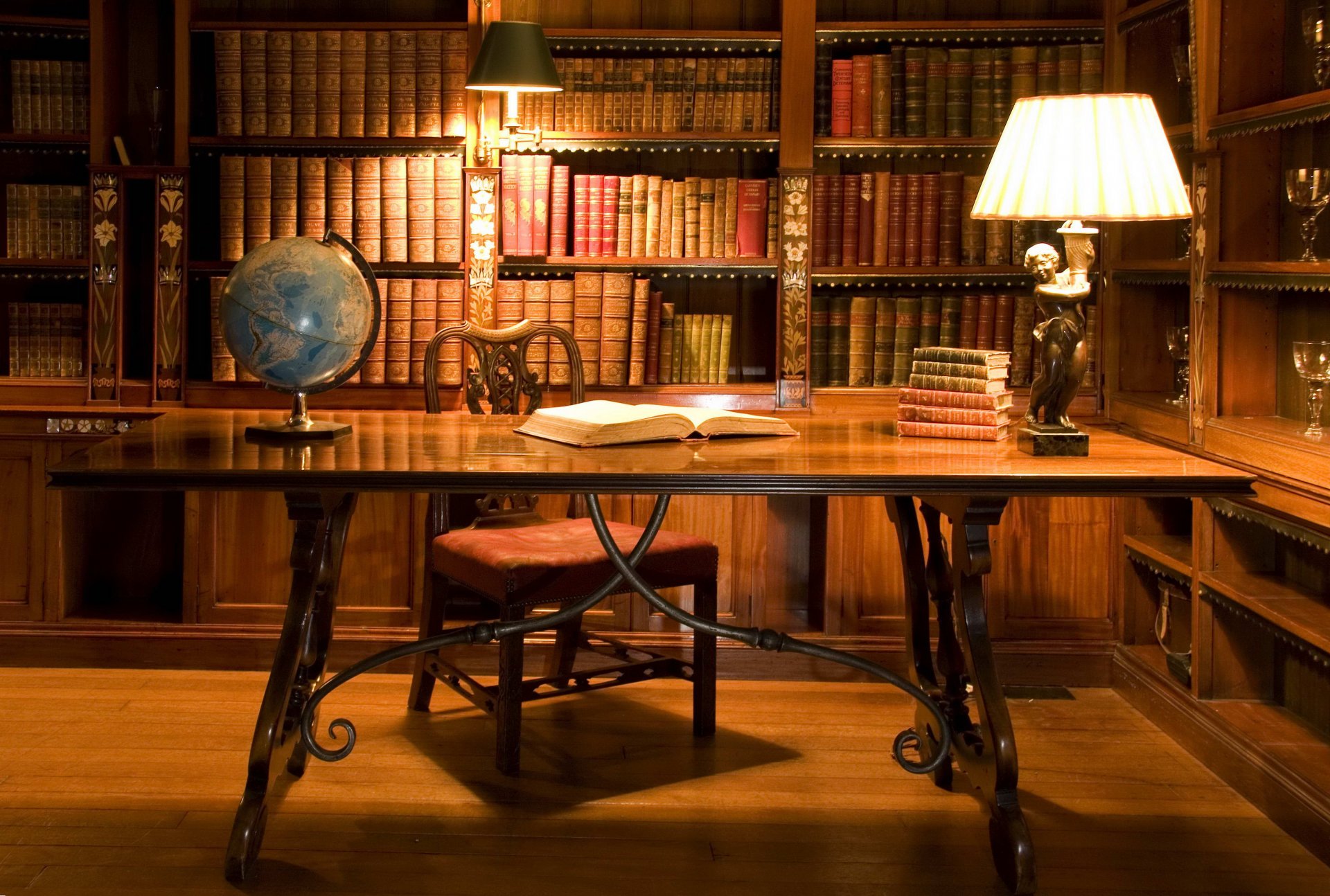 room table chair globe light shelf books library glasses old