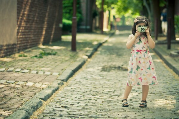 A girl takes pictures of the streets