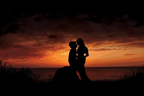 Silhouettes of a girl and a guy against the sunset