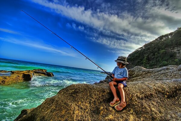 Fishing on the sea. A boy with a fishing rod