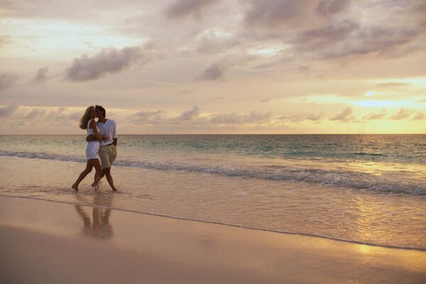 Lovers walk along the seashore