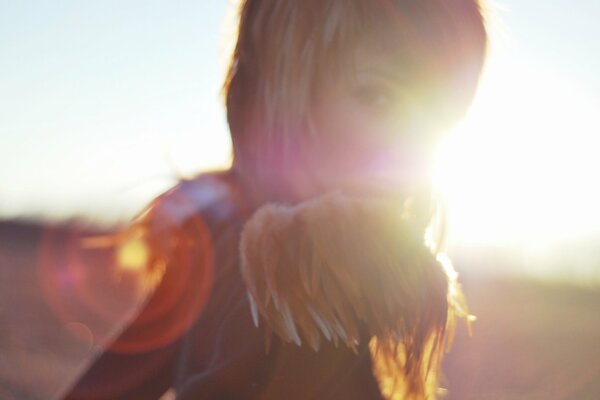 Photo of a beautiful girl against the background of sunlight