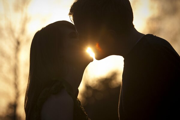 Gentle kiss of a couple at sunset