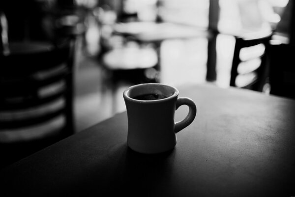 A lonely mug of coffee in an empty cafe