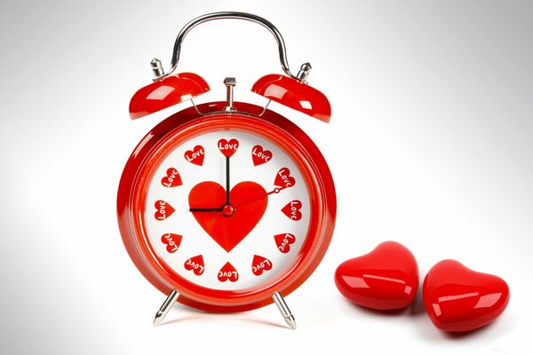 Red old alarm clock with love hearts