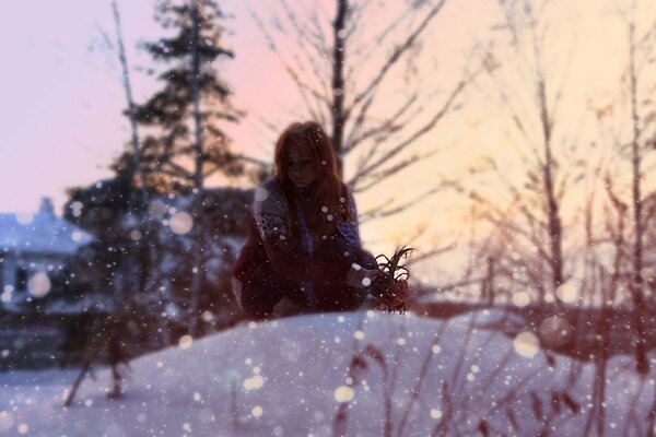 A red-haired girl is not cold in the snow in winter