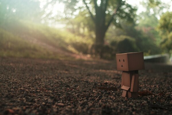 A sad robot is walking down the road