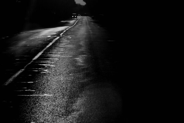 Black and white road with a car