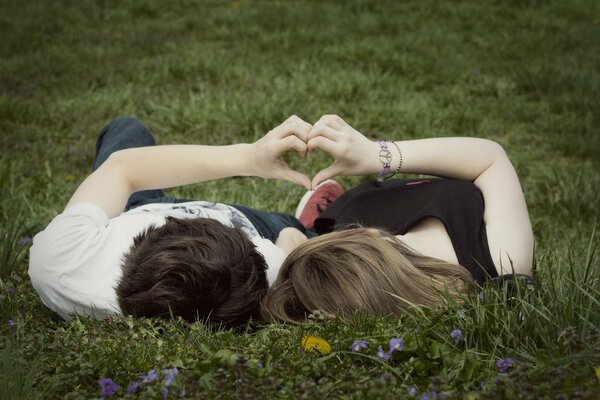 Tender love of a couple on the grass