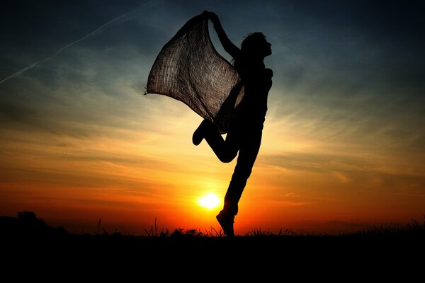 Silhouette of a girl at sunset