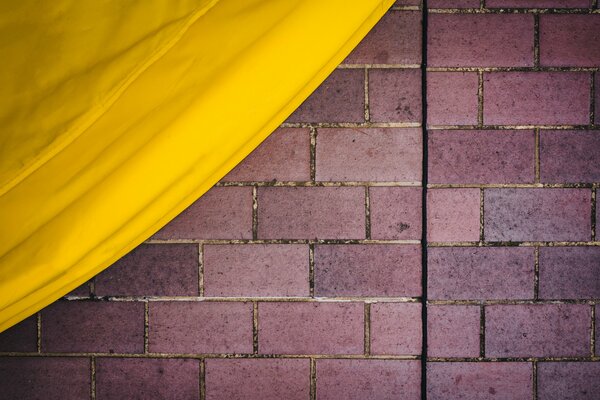 Mur de briques et tissu jaune