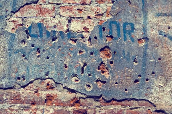 The texture of paint on a brick wall