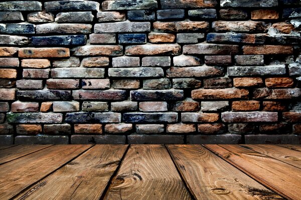 The floor is made of planks, resting against a brick wall