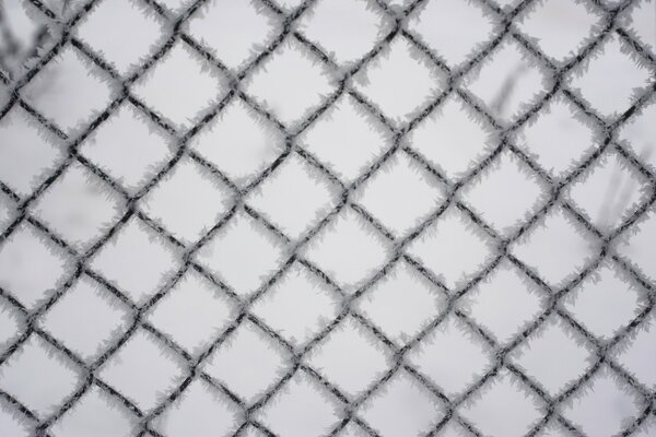 A fence made of wire, torn by rain