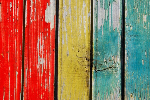 Fence made of colored painted wooden boards