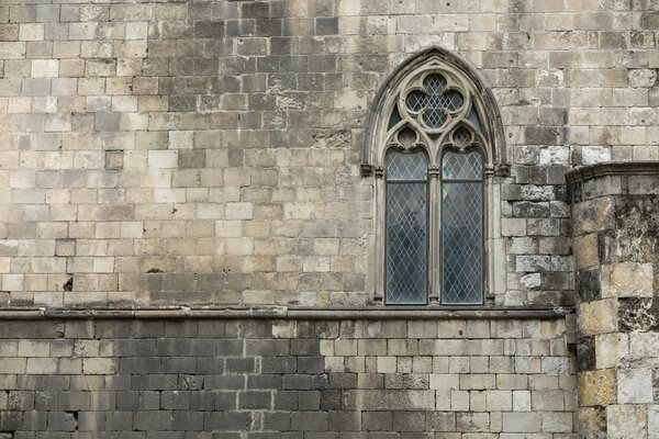 View of an old stone wall with a window