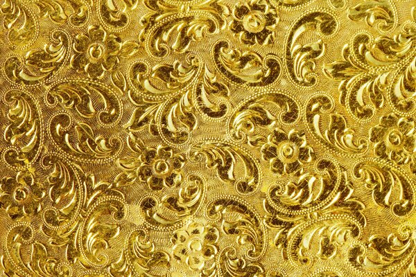 Pattern of feathers and flowers on a golden background