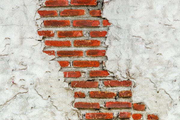 Red brick wall with white plaster