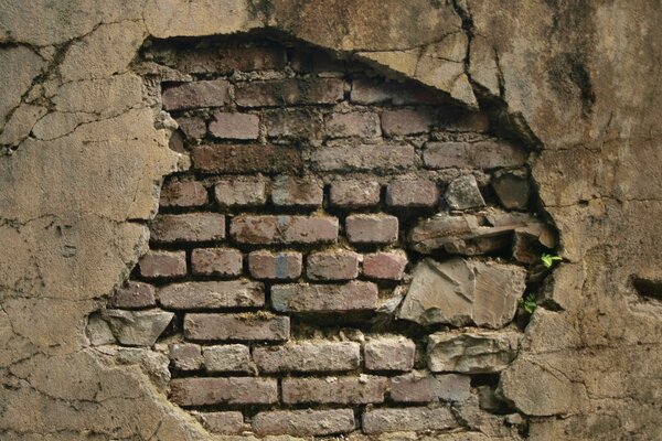 A crack in a brick wall with cracks