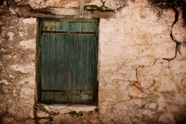 Stone wall and green shutters