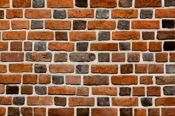 A wall made of a variety of bricks