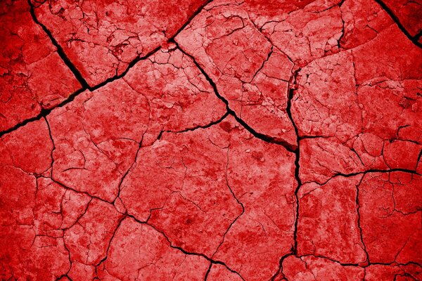 Красная текстура на фоне трещин земли
