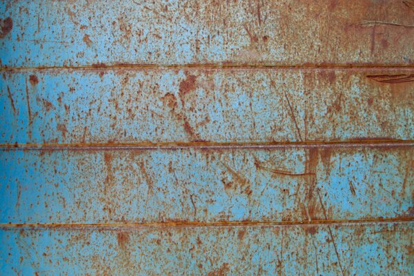 Image of a blue rusty and old metal wall