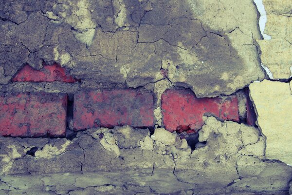 Image of an old orange brick wall and fallen plaster