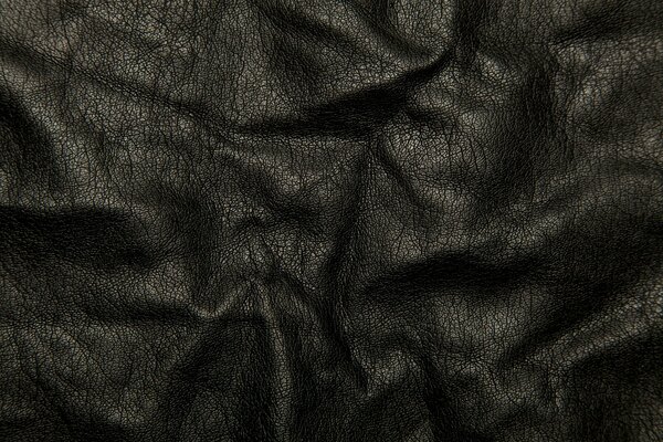 Textur von schwarzem Leder in Falten