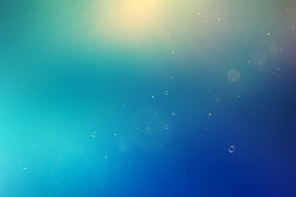 Su sfondo blu bolle su un bagliore di luce
