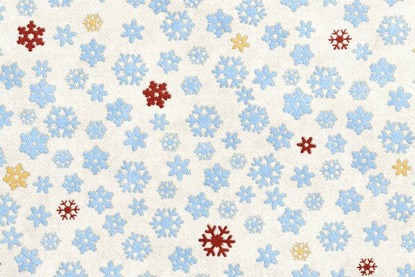 Fabric background - blue snowflakes interspersed with red and yellow
