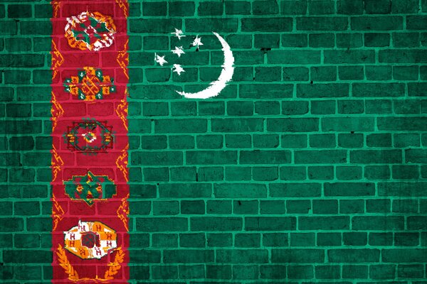 Turkmen flag on the background of a brick wall