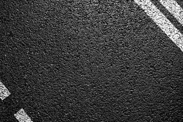 Czarny asfalt z oznaczeniami białymi paskami
