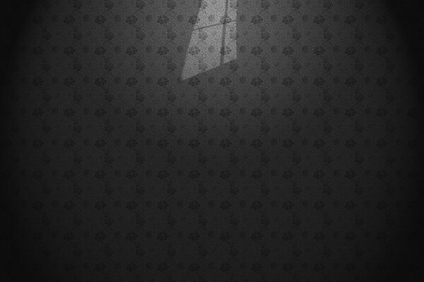 The shadow of the window on the gray wallpaper