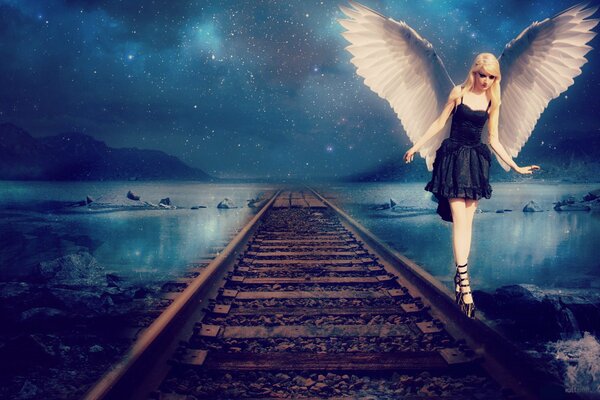 Fantasy girl with wings walks on rails