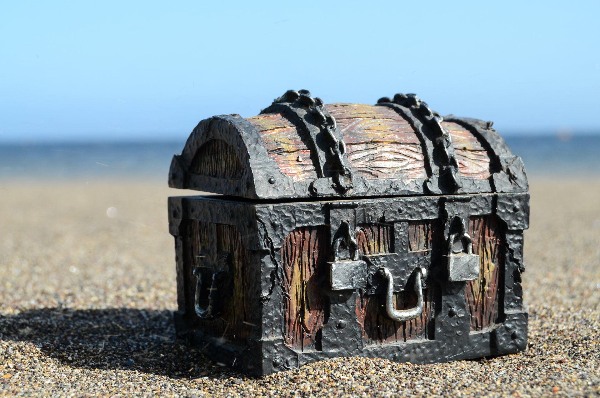 old treasure chest chains locks wood metal sand