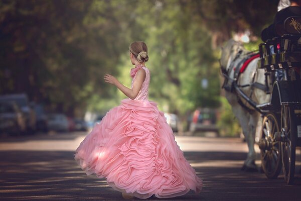 Mädchen in einem üppigen rosa Kleid auf der Straße