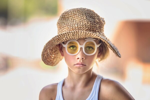 Girl in a hat portrait from nature