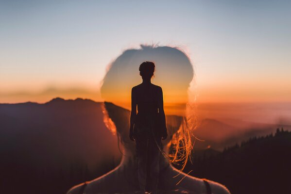 Double exposure of a girl against a sunset background