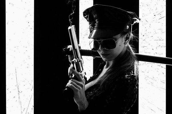 Black and white photo of a girl with a revolver