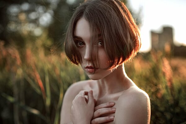 A girl with a square in a green field