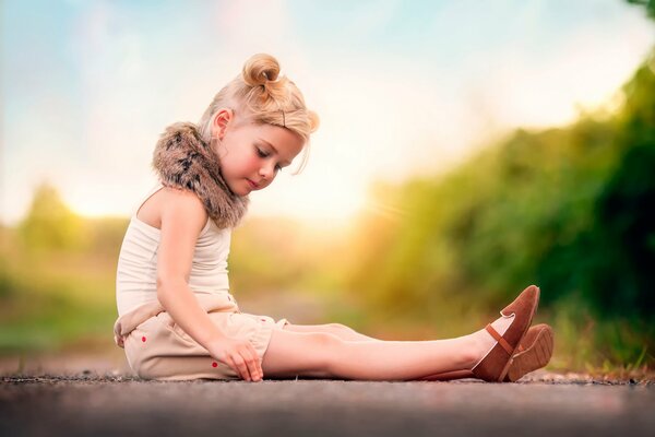 A girl in a fur collar on the road