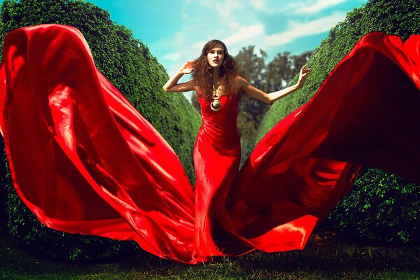 Brown-haired woman in a long scarlet dress