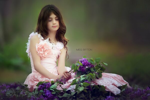 A girl in the garden with a bouquet of flowers